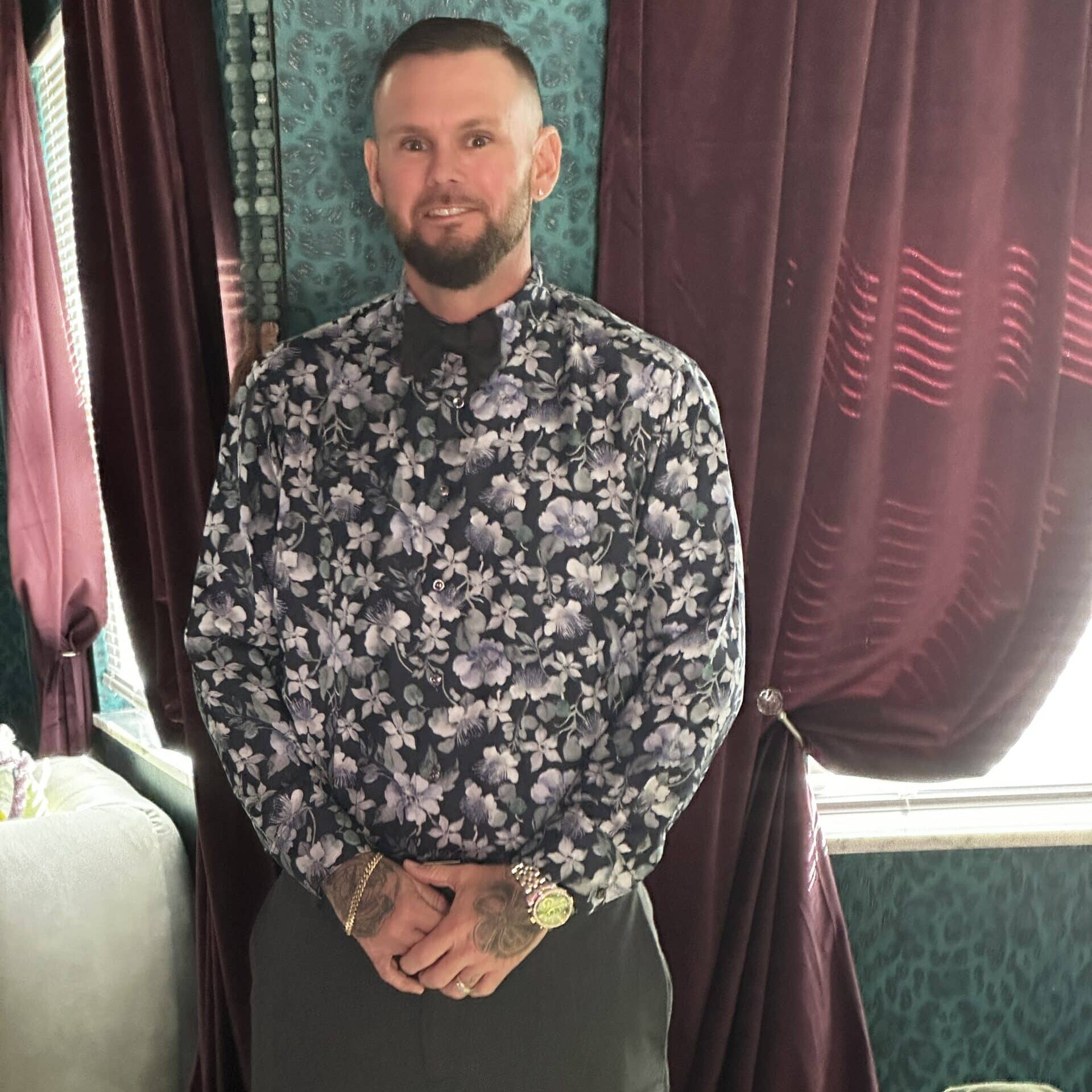 a man standing in front of a curtain