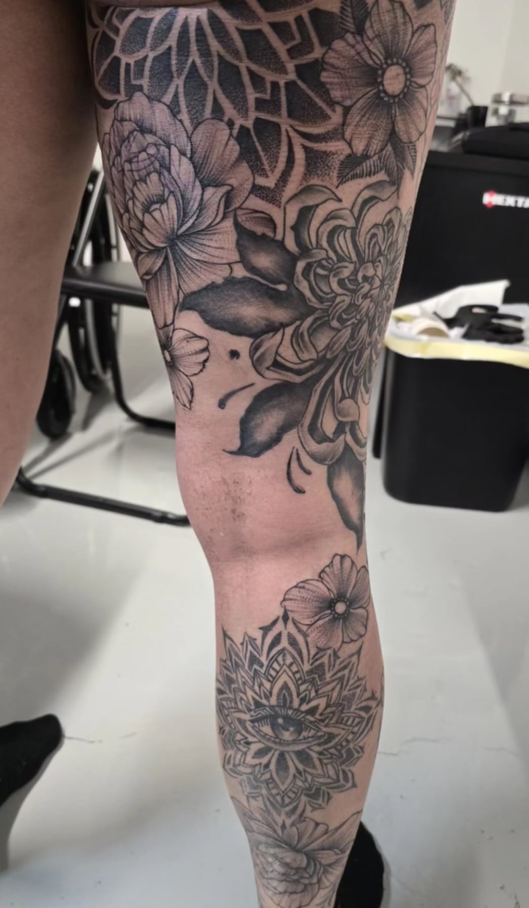 a tattoo of a vase on a table